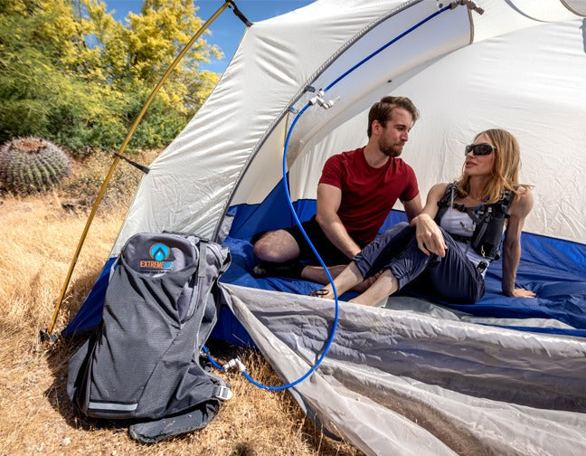 backpack outside of tent supplying water for misting system