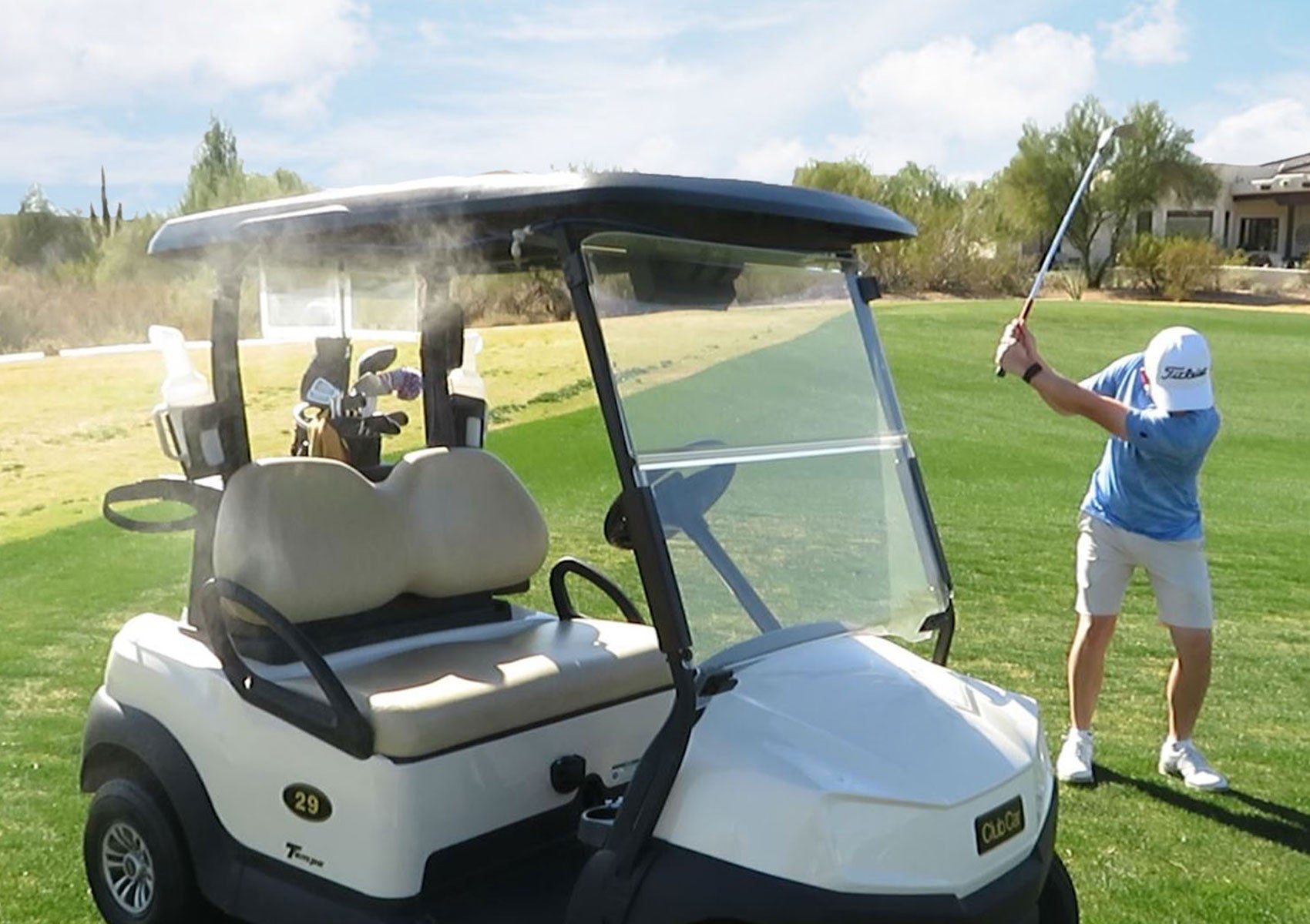 Man playing golf and using the Portable Misting System mounted on a Golf Cart
