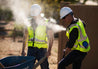 road workers outside with hi vis misting vest in hot weather